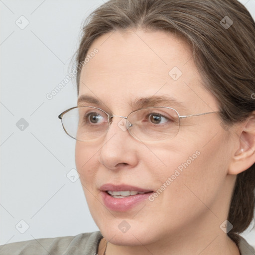 Joyful white adult female with medium  brown hair and blue eyes