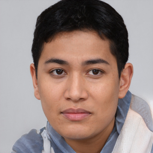 Joyful asian young-adult male with short  black hair and brown eyes