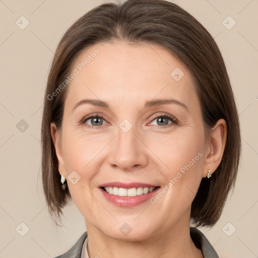 Joyful white adult female with medium  brown hair and grey eyes