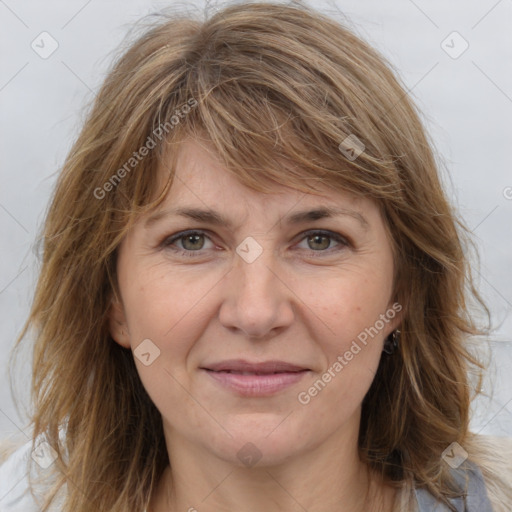 Joyful white adult female with medium  brown hair and grey eyes