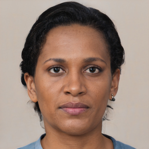 Joyful black young-adult female with short  brown hair and brown eyes