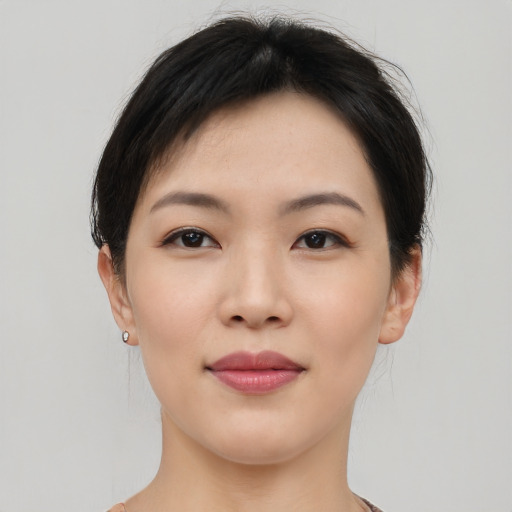 Joyful asian young-adult female with short  black hair and brown eyes