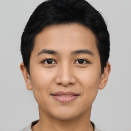 Joyful asian young-adult male with short  black hair and brown eyes