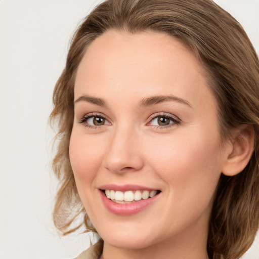 Joyful white young-adult female with long  brown hair and green eyes