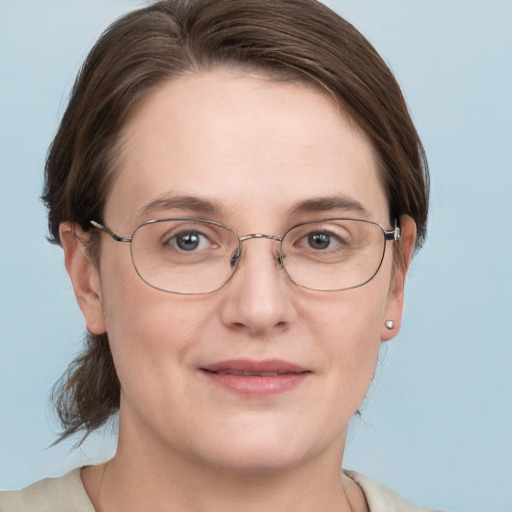 Joyful white adult female with short  brown hair and grey eyes