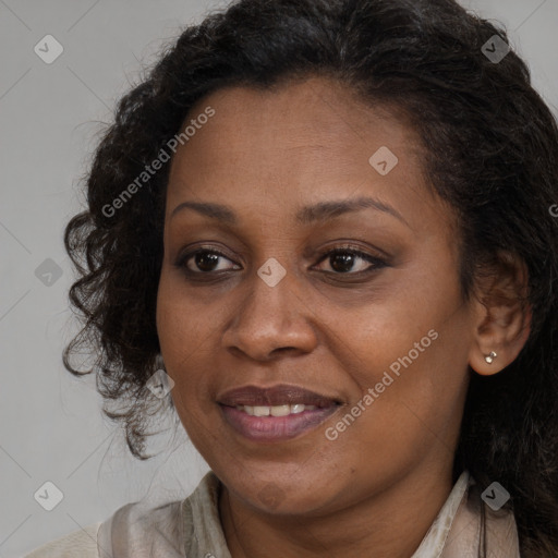 Joyful black adult female with long  brown hair and brown eyes