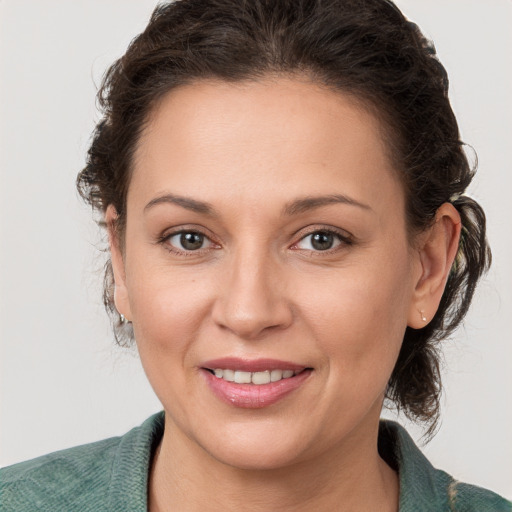 Joyful white adult female with medium  brown hair and grey eyes