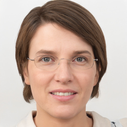 Joyful white adult female with medium  brown hair and grey eyes