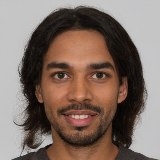 Joyful latino young-adult male with medium  black hair and brown eyes