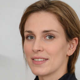 Joyful white young-adult female with medium  brown hair and blue eyes