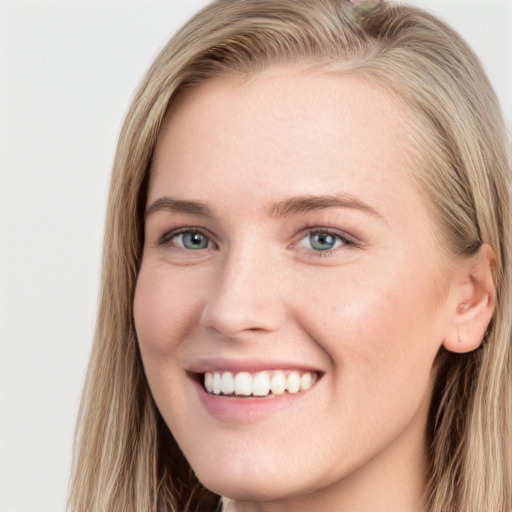 Joyful white young-adult female with long  brown hair and blue eyes