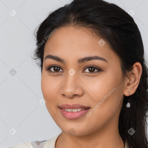 Joyful latino young-adult female with long  brown hair and brown eyes