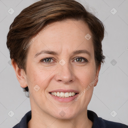 Joyful white adult female with short  brown hair and grey eyes