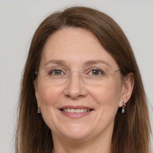 Joyful white adult female with long  brown hair and grey eyes