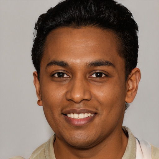 Joyful black young-adult male with short  black hair and brown eyes