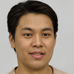 Joyful asian young-adult male with short  brown hair and brown eyes