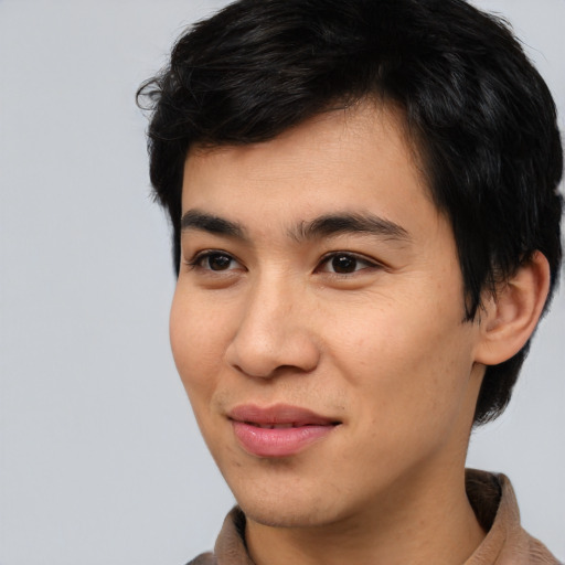 Joyful asian young-adult male with short  brown hair and brown eyes