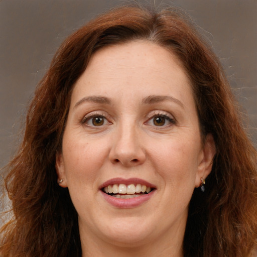 Joyful white adult female with long  brown hair and brown eyes