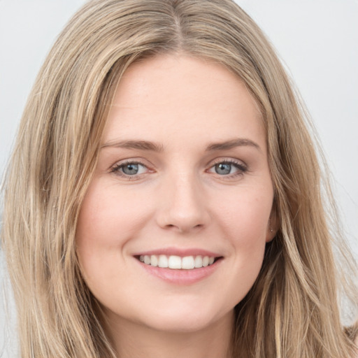 Joyful white young-adult female with long  brown hair and blue eyes