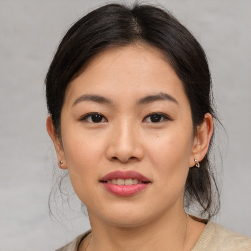 Joyful asian young-adult female with medium  brown hair and brown eyes