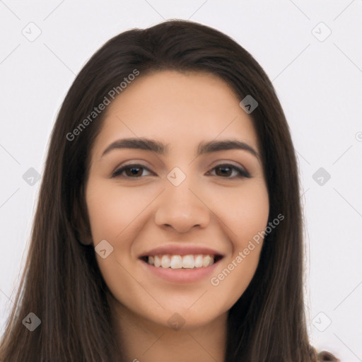 Joyful latino young-adult female with long  brown hair and brown eyes