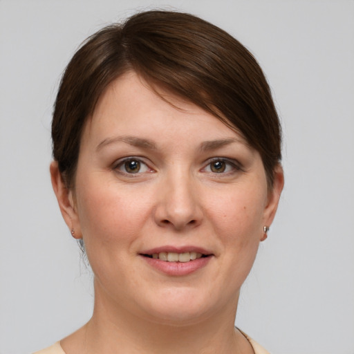 Joyful white young-adult female with short  brown hair and grey eyes