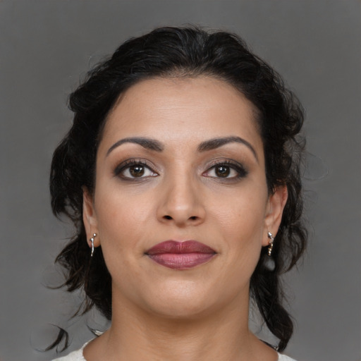 Joyful latino young-adult female with medium  brown hair and brown eyes