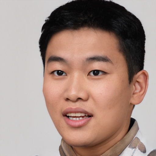 Joyful asian young-adult male with short  black hair and brown eyes