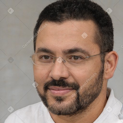 Joyful white adult male with short  black hair and brown eyes