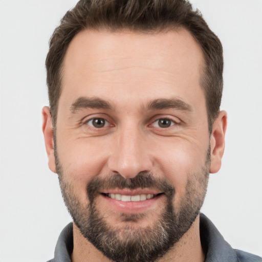 Joyful white young-adult male with short  brown hair and brown eyes