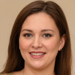 Joyful white young-adult female with long  brown hair and green eyes