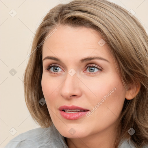 Joyful white young-adult female with medium  brown hair and blue eyes