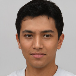 Joyful asian young-adult male with short  black hair and brown eyes