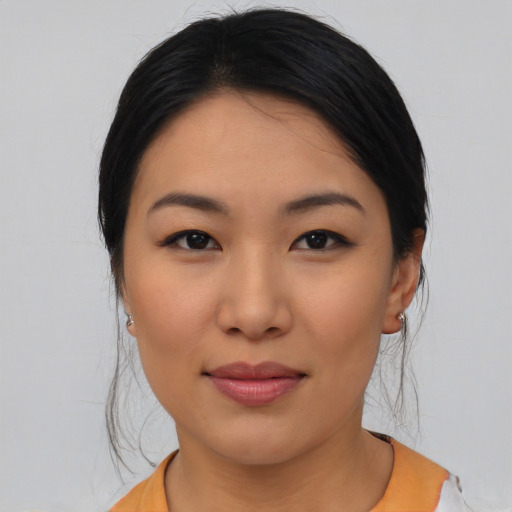 Joyful asian young-adult female with medium  black hair and brown eyes