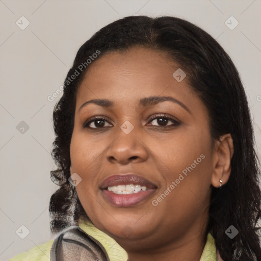 Joyful black young-adult female with long  brown hair and brown eyes