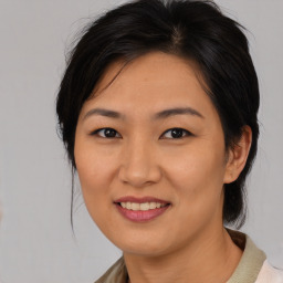 Joyful asian young-adult female with medium  brown hair and brown eyes