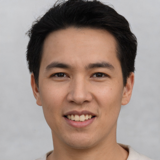 Joyful white young-adult male with short  black hair and brown eyes