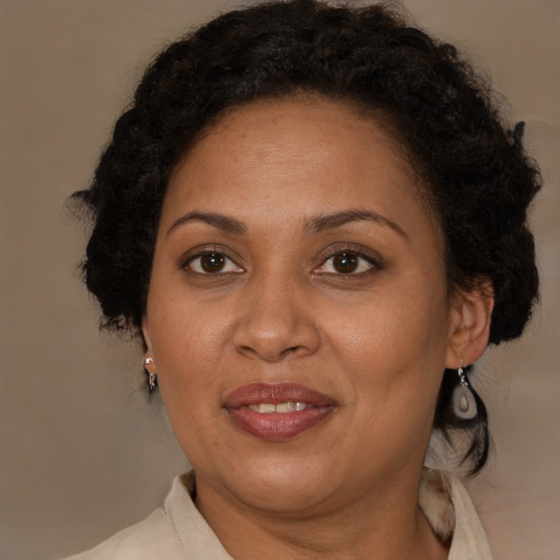 Joyful black adult female with medium  brown hair and brown eyes