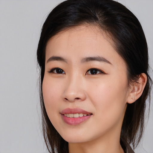 Joyful asian young-adult female with long  brown hair and brown eyes