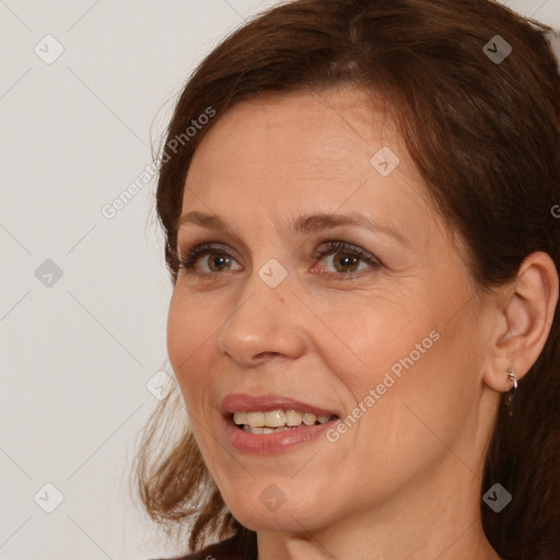 Joyful white adult female with medium  brown hair and brown eyes