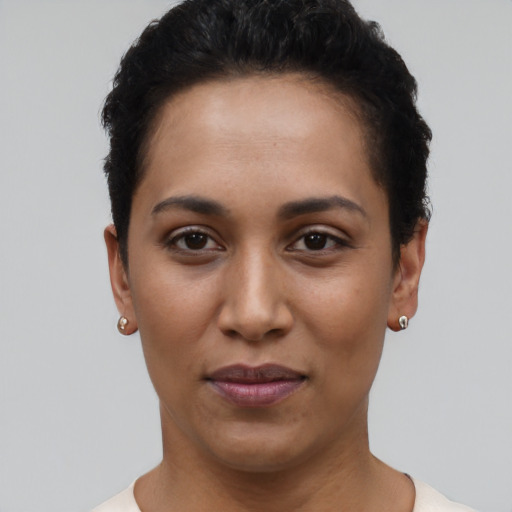 Joyful latino young-adult female with short  black hair and brown eyes