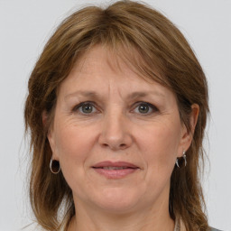 Joyful white adult female with medium  brown hair and grey eyes