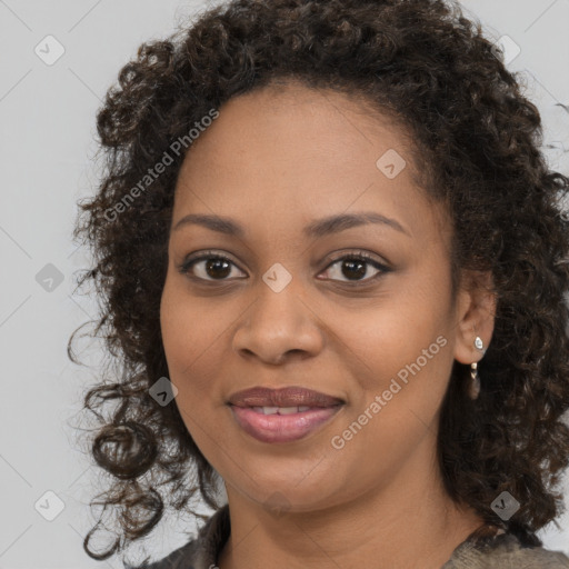 Joyful black young-adult female with long  brown hair and brown eyes