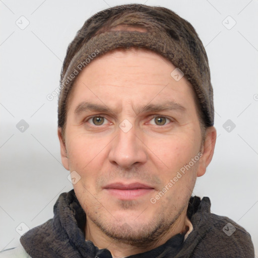 Joyful white adult male with short  brown hair and grey eyes