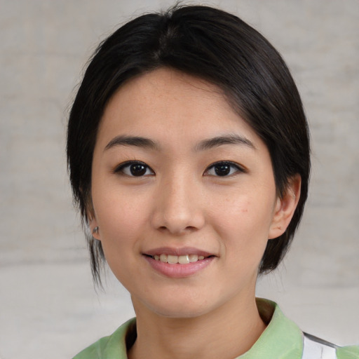 Joyful asian young-adult female with medium  black hair and brown eyes