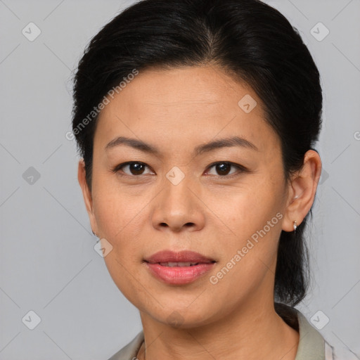 Joyful asian adult female with medium  brown hair and brown eyes