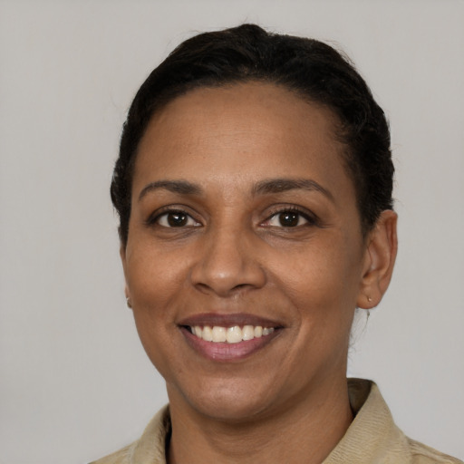 Joyful black young-adult female with short  brown hair and brown eyes