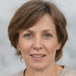 Joyful white adult female with medium  brown hair and grey eyes