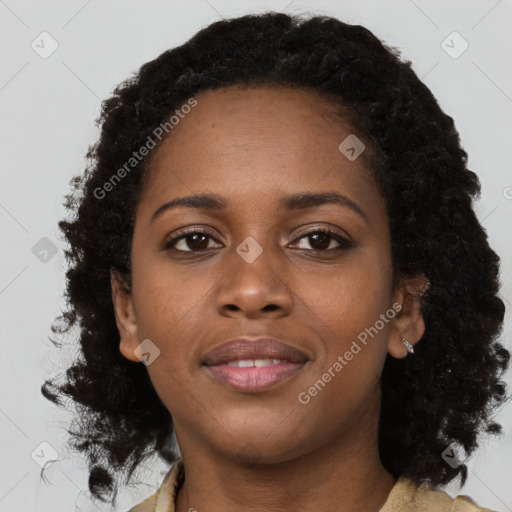 Joyful black young-adult female with long  brown hair and brown eyes