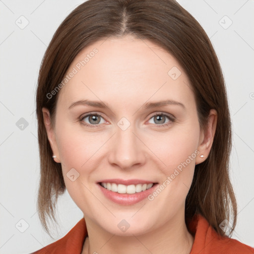 Joyful white young-adult female with medium  brown hair and grey eyes